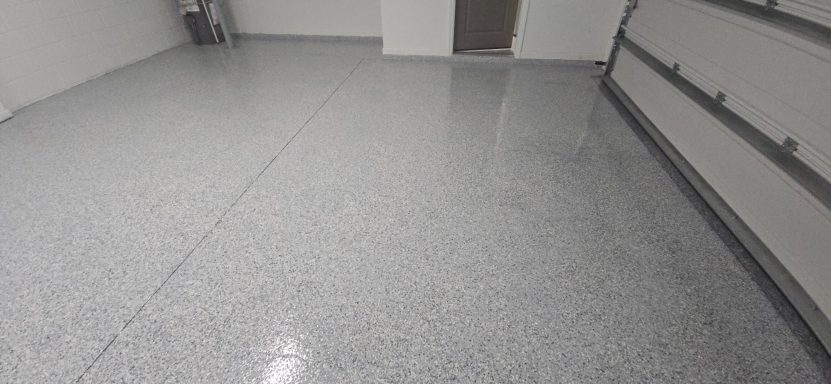 Clean, shiny gray epoxy floor in a well-lit garage.